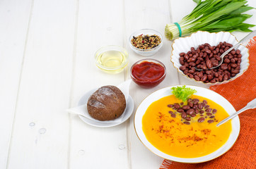 Vegetable vegetarian carrot pumpkin soup cream with red beans