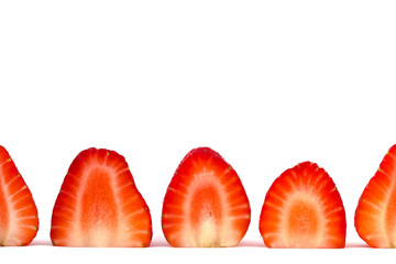 Plate of sliced strawberries isolated on white background. Strawberry berry on a white background. Neatly arranged slices of red strawberry on a white background.