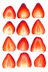 Plate of sliced strawberries isolated on white background. Strawberry berry on a white background. Neatly arranged slices of red strawberry on a white background.