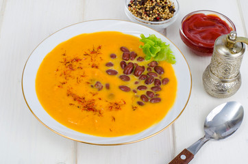 Vegetable vegetarian carrot pumpkin soup cream with red beans