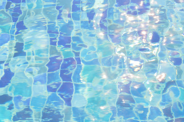 Blue pool water with sun reflections