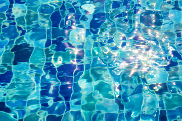 Blue pool water with sun reflections