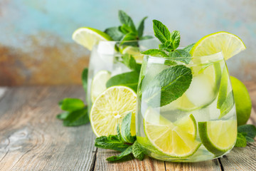 Two Mojito cocktail with ice cubes in a glass.