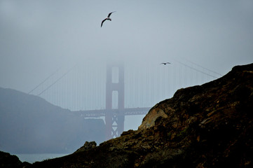 Fog obscures Golden Gate Bridge. View from Baker Beach, San Francisco, California 