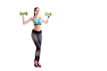 Fototapeta na wymiar Young sportive woman fitness model brunette doing exercise with dumbbell on biceps on white isolated background. Fit girl living an active lifestyle