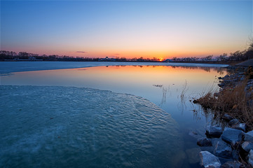 The ice and snow was melting in spring in the park.