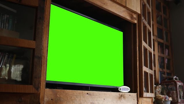 Green screen television in rustic entertainment center
