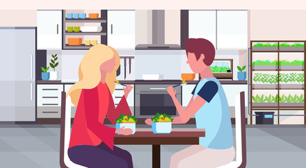 couple sitting at table man woman eating fresh fruits salad healthy food concept modern home room with smart plants growing system kitchen interior flat horizontal portrait