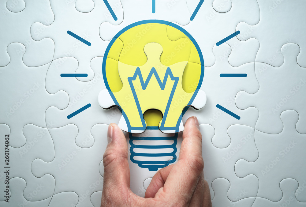 Aufkleber Concept image of solution.  Finding answer to problem.Solving lightbulb jigsaw puzzle.