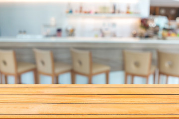 Abstract image of Empty wooden table with blurred coffee cafe.