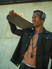 cool isolated young attractive and confident hipster black African American man walking on street...
