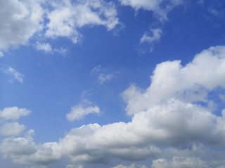blue sky with white, soft clouds.The sky is clear.