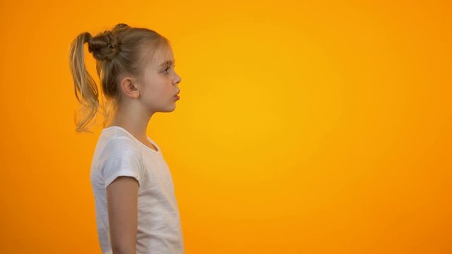 Tired preteen girl shouting in megaphone, relieving stress, children rights