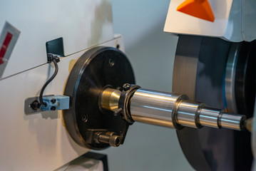 The cylindrical grinding machine.The automotive part manufacturing process.