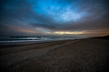 Colorful beach sunrise with a vibrant sky line 