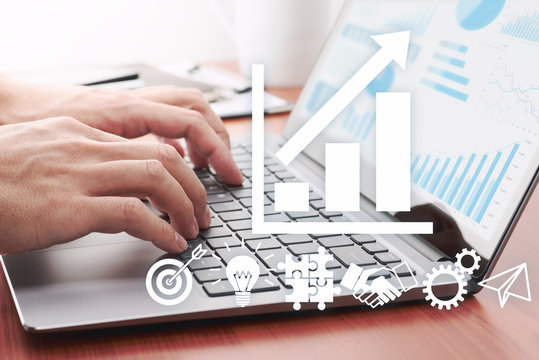 Business development strategy concept. Businessman preparing reports.Man using laptop. Many icons and growth graphs.