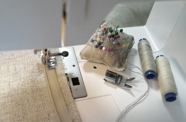 Needlework. Sew on a sewing machine at home. Using a special narrow presser foot to stitching of...