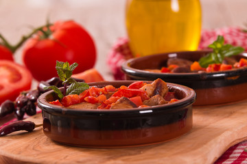 Marinated pork loin in tomato sauce.