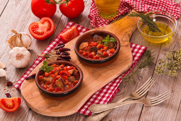 Marinated pork loin in tomato sauce.