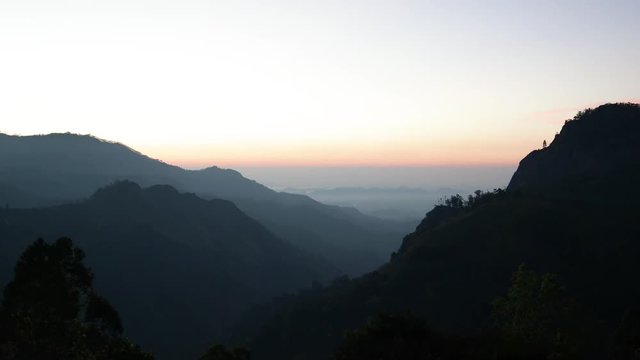 Looped 4k footage of a sunrise at the mountains. View to the Little Adam's peak, Sri-Lanka.