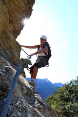 Pretty young woman in via ferrata at Simms waterfall