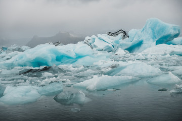 Glacier water covered in ice floes in Nordic landscape in Iceland