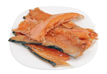 Hot smoked   salmon trim and leftovers with bones and fins low cost delicacy on plate isolated