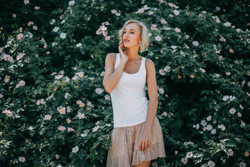 Young girl in blooming pink flowers