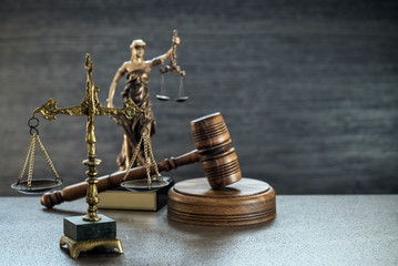 Law and Justice concept. Gray stone background, reflections on the floor, place for typography. Courtroom theme.