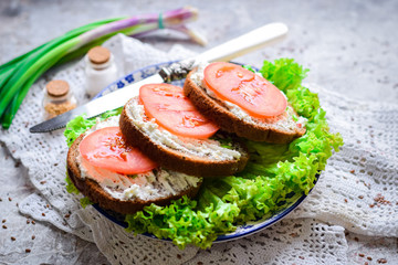 Sandwiches with cottage cheese filling, fresh tomatoes and lettuce.