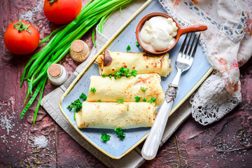 Pancakes with meat and sour cream.