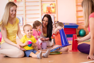 Kids playing with sport equipment in nursery gym