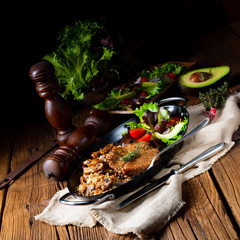 Pork steak with mushrooms and buckwheat groats and mango salad