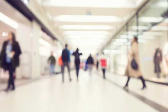 Blurred image of people in shopping mall with bokeh, vintage color
