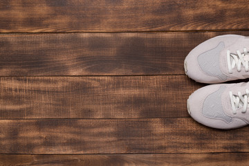 Sneakers on wooden background.