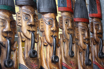 Carved wooden figures on display in a market in Thailand