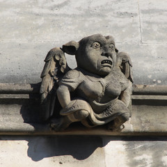 Curious gargoyle sculptures on historic building