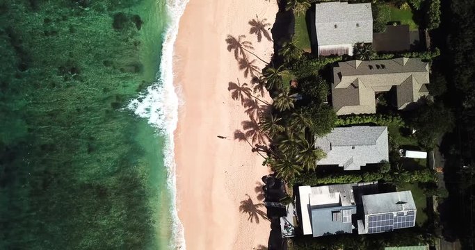 Aerial View: Moving Towards Section of Beachfront with Ocean, Beach & Rooftops in Oahu, Hawaii