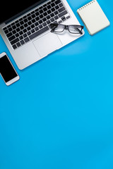 Creative flat lay photo of modern workplace with laptop, top view laptop background and copy space on blue background  background, Above view shot of Computers,laptop background