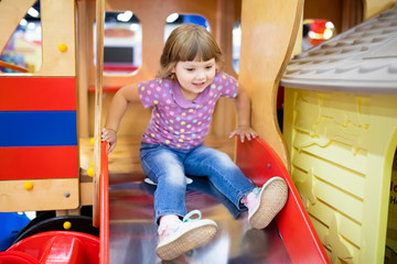 Little kid on playground, children's slide