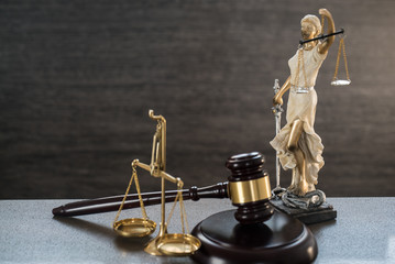 Law and Justice concept. Gray stone background, reflections on the floor, place for typography. Courtroom theme.