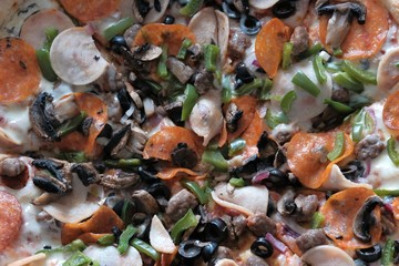 Vegetable pizza with with mushrooms. Food background for design. Close-up. Daylight. Texture of hot traditional italian dish.