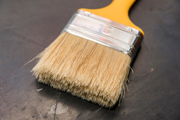 Brush with yellow handle.