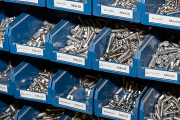 Rack with stainless steel material in plastic blue boxes.