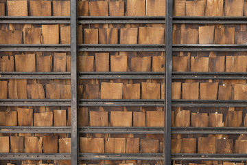 pieces of wooden plank wall with black steel shelves.