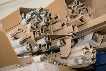 Discarded fluorescent tubes in paper packaging.