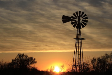 Kansas Windmill Silhouette  at Sunset with clouds