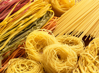  top view different types, colour of pasta and geometric shape on table 
