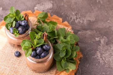 Cake dessert. Chocolate mousse with blueberry, mint and cinnamon