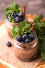 Cake dessert. Chocolate mousse with blueberry, mint and cinnamon